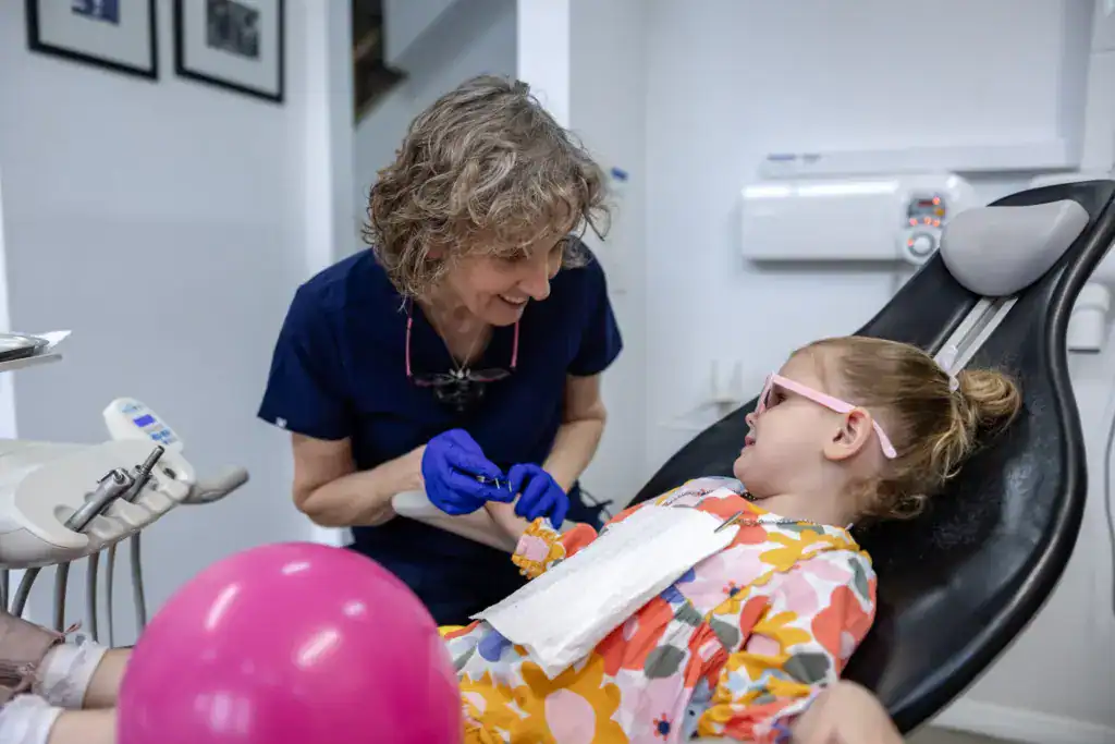 Dr Slater with a young patient in the chair