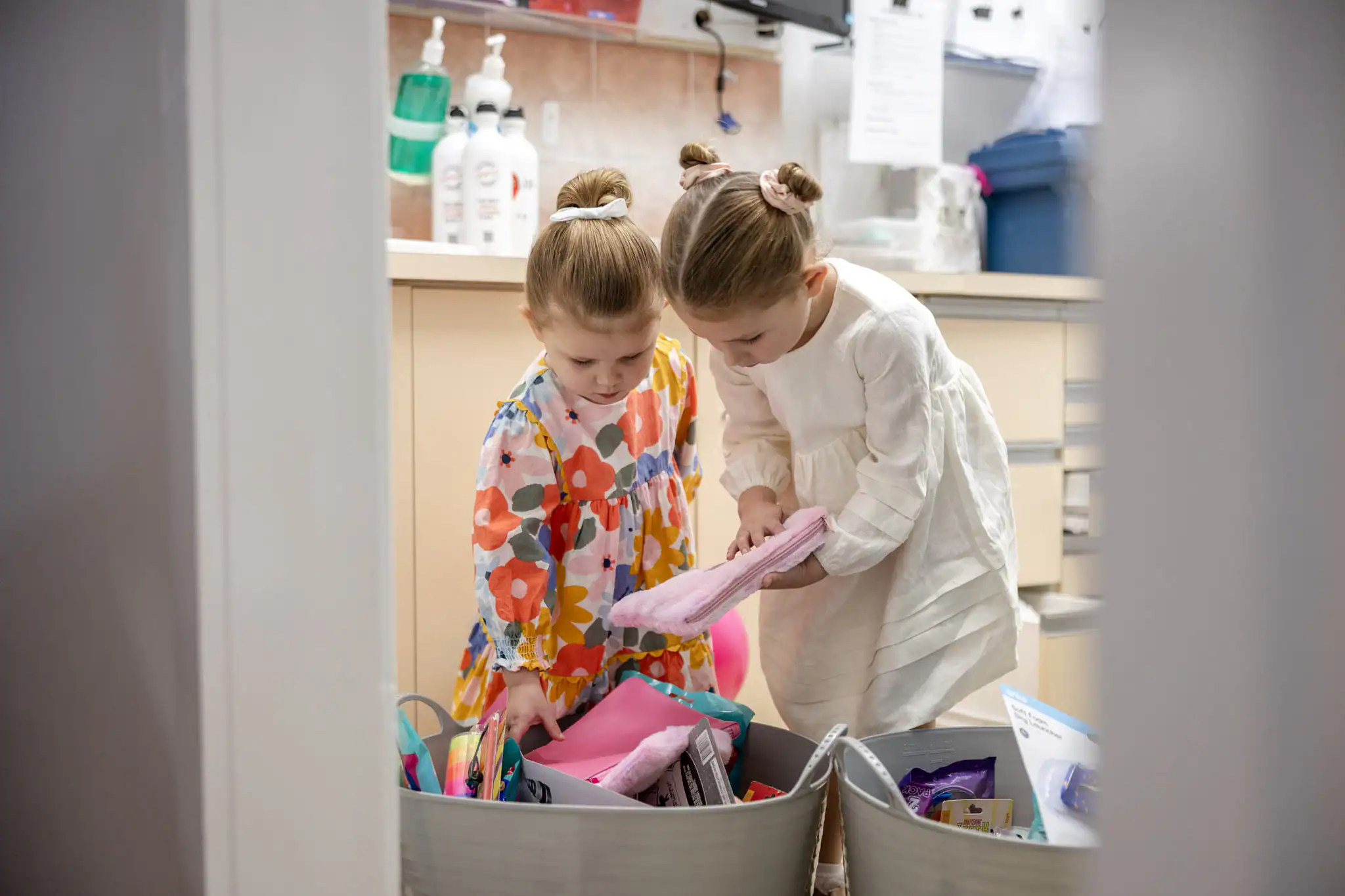 Two children choosing from the practice toy box