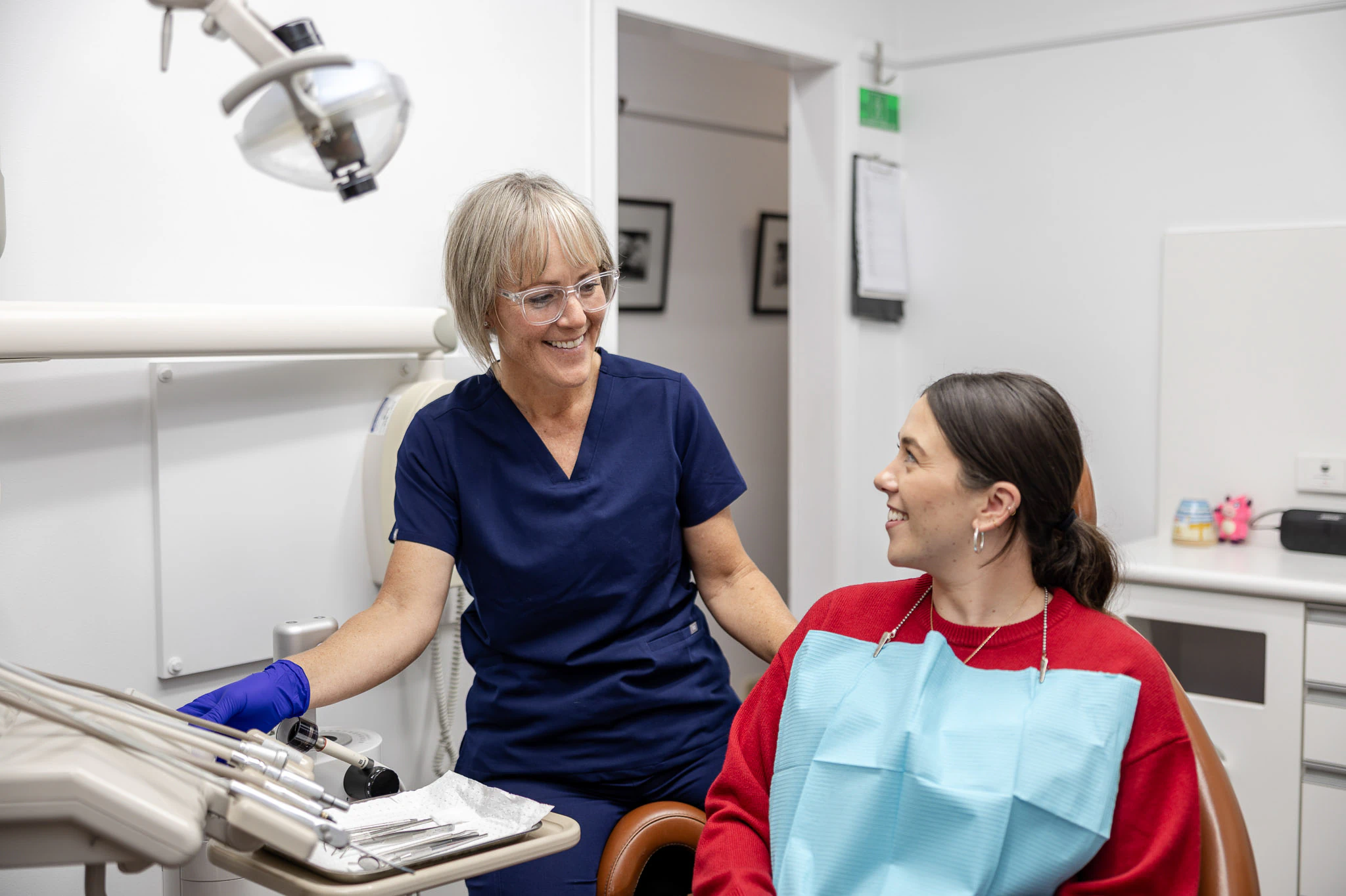 Clinician talking with a patient in the chair