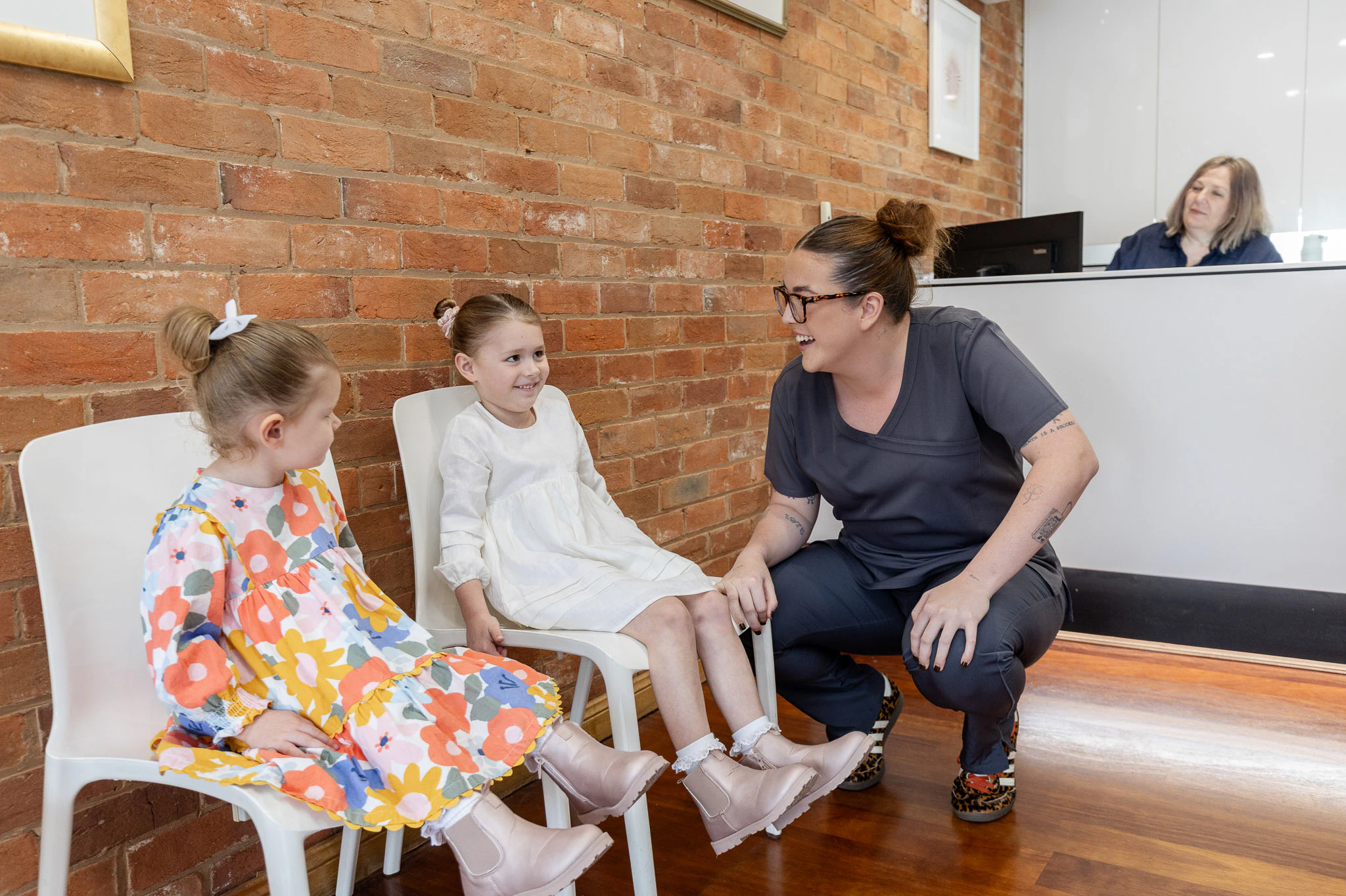 Children waiting in the practice reception with a team member